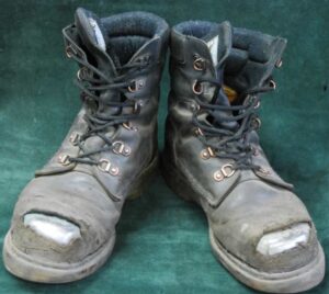 Worn boots without toe caps